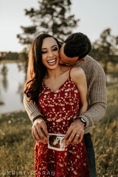 a man and woman hugging each other while holding a coffee cup in front of the camera