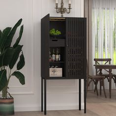 a tall cabinet sitting next to a potted plant in a room with white walls