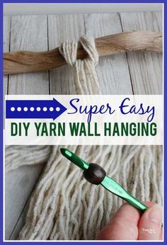 the yarn is being used to make an easy diy yarn wall hanging