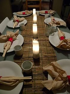 the table is set with white plates and place settings