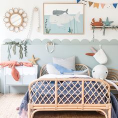 a child's bedroom decorated in blue and white with fish decorations on the wall