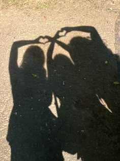 the shadow of two people standing next to each other