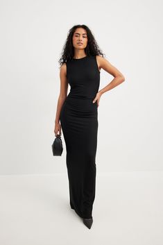 This maxi dress is sleeveless and features a rounded high neckline. It has ruched side seams and a back slit detail. This maxi dress features a stretchy material. America Dress, Ruched Maxi Dress, Net Dress, Houndstooth Dress, Crewneck Dress, Maxi Knit Dress, Tube Dress, Sleeveless Maxi Dress, Vacation Outfits