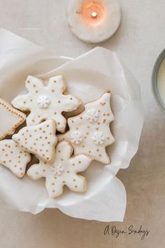 some cookies are on a plate next to a candle