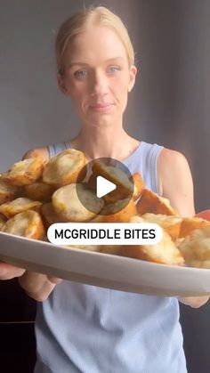 a woman holding a plate full of food with the words mcgriddle bites on it