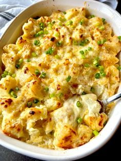 a casserole dish with peas and cheese in it on a blue table cloth