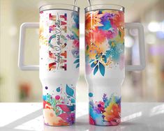 two travel mugs with the words mom and free tumbler drive included