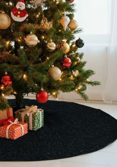 a small christmas tree with presents under it