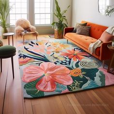 a living room with an orange couch and colorful rug on the floor in front of a window