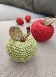 two crocheted apples sitting next to each other