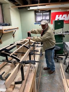 a man working on some wood in a shop