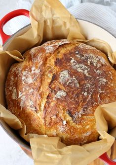 a loaf of bread sitting in a red pot