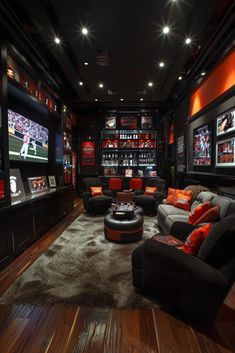 a room with several couches and televisions on the wall, including one that has an orange pillow