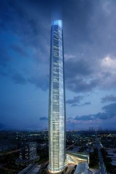 an aerial view of a tall skyscraper with lights shining on it's sides at night