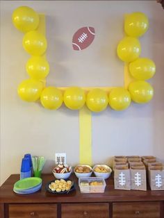 a football themed party with balloons and snacks