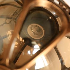 a close up view of the inside of a glass and metal object with light shining through it