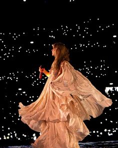 a woman in a white dress on stage