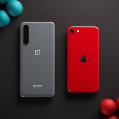 two red and gray iphones sitting next to each other on a black surface with blue balls