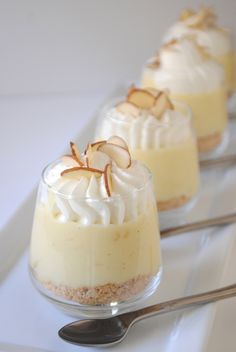 three small desserts with whipped cream and nuts on top