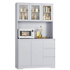 a white microwave oven sitting on top of a counter next to a cabinet with glass doors