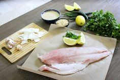 raw fish and ingredients on a cutting board