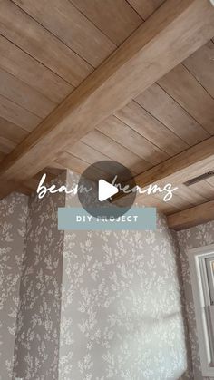 a room with wooden ceilings and wallpaper on the ceiling is shown in this video