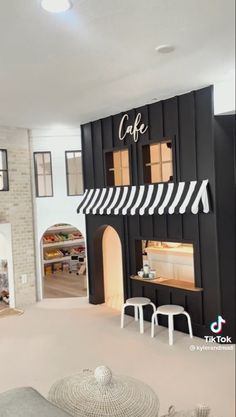 the interior of a restaurant with black and white decor on the walls, tables and stools