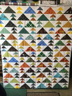 a large quilt is hanging on the wall