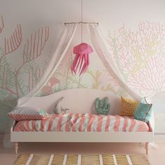 a white bed sitting under a canopy in a bedroom next to a wall with coral and sea life on it