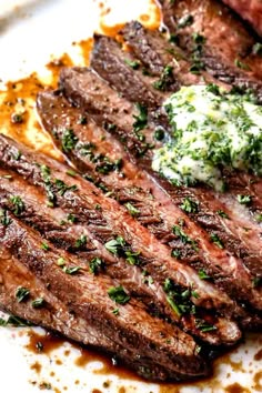 grilled steak with herbs and butter on a white plate