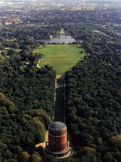 an aerial view of a large field and trees