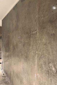 an empty room with concrete walls and no one on the floor or in the background