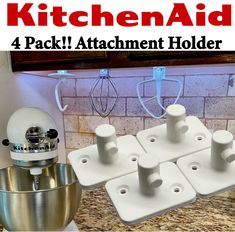 the kitchen aid attachment holder is set up next to a mixer