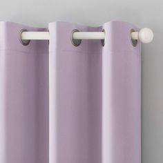 purple curtains hanging on the side of a window with white handles and two round knobs