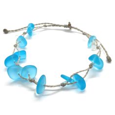 Gorgeous beach bracelet or anklet made with turquoise blue and white sea glass pebbles on our durable hand spun rope cord. Pure island style! Easy and secure adjustable slide knot closure allows for easy on and off. This bracelet/anklet is completely waterproof and metal free making it perfect for anyone with skin sensitivities and is a wonderful and unique gift for those hard to shop for friends and family on your list, especially the beach lovers! Color: Turquoise blue Size: Available in three Adjustable Blue Beachy Jewelry, Blue Adjustable Beachy Jewelry, Adjustable Strand Jewelry For Beach, Adjustable Cord Strand Jewelry For The Beach, Beachy Blue Adjustable Jewelry, Bohemian Recycled Glass Bracelets For Beach, Handmade Adjustable Sea Glass Bracelets, Beaded Sea Glass Jewelry For Beach, Adjustable Ocean Colored Beaded Jewelry