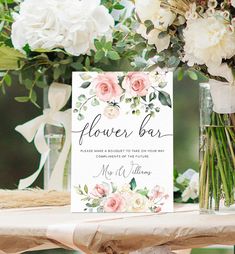 a bouquet bar sign sitting on top of a table next to vases with flowers