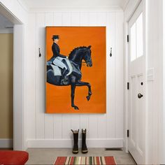 an orange and black horse painting hangs on the wall