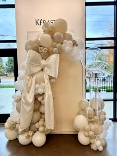 balloons and bows are tied to the top of a cake