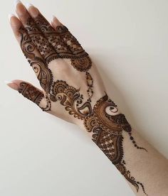 a woman's hand with hennap on it, showing the intricate design