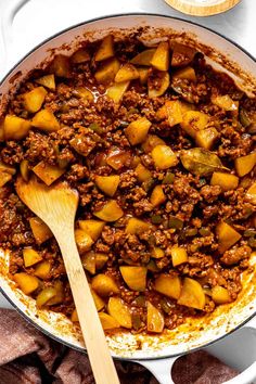 a skillet filled with meat and potatoes