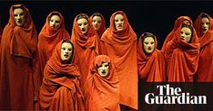 several mannequins dressed in red are lined up with heads covered by veils