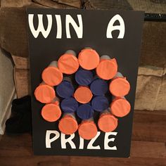 a sign that says win a prize with orange, blue and grey circles on it