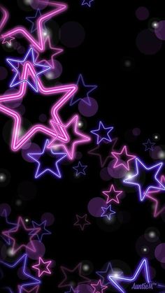 an abstract background with many stars in purple and pink colors on a black background that is very blurry