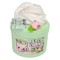 a green container filled with white whipped cream and other items on top of it's lid