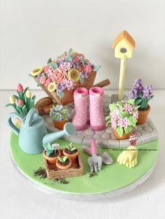 there is a cake decorated with flowers and gardening items