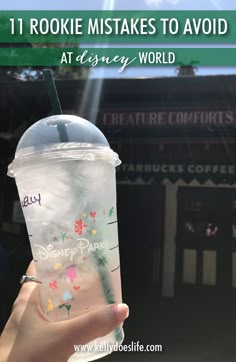 someone holding up a starbucks cup with the words disney world on it