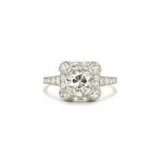 An old European cut diamond weighing approximately 1.50 carats is set within a surround featuring scroll motifs at the corners in a platinum ring accented with a total of approximately 0.80 carat of old European cut diamonds. Circa 1915. Platinum Cluster Ring With Single Cut Diamonds, Classic White Halo Ring With Rose Cut Diamonds, Art Deco Platinum Halo Ring With Center Stone, Platinum Halo Ring With Single Cut Diamonds, Classic Platinum Halo Ring With Diamond Accents, Classic Platinum Halo Ring With Center Stone, Vintage Halo Ring With Round Cut, Vintage Halo Ring With Round Cut Setting, Vintage Platinum Halo Ring With Brilliant Cut