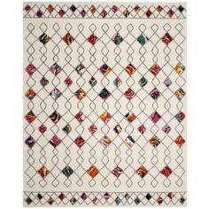 a white rug with multicolored diamonds on it