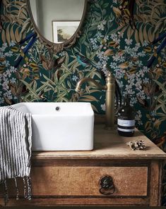 a white sink sitting on top of a wooden dresser