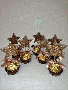 chocolate cupcakes decorated with gold stars and pink bows